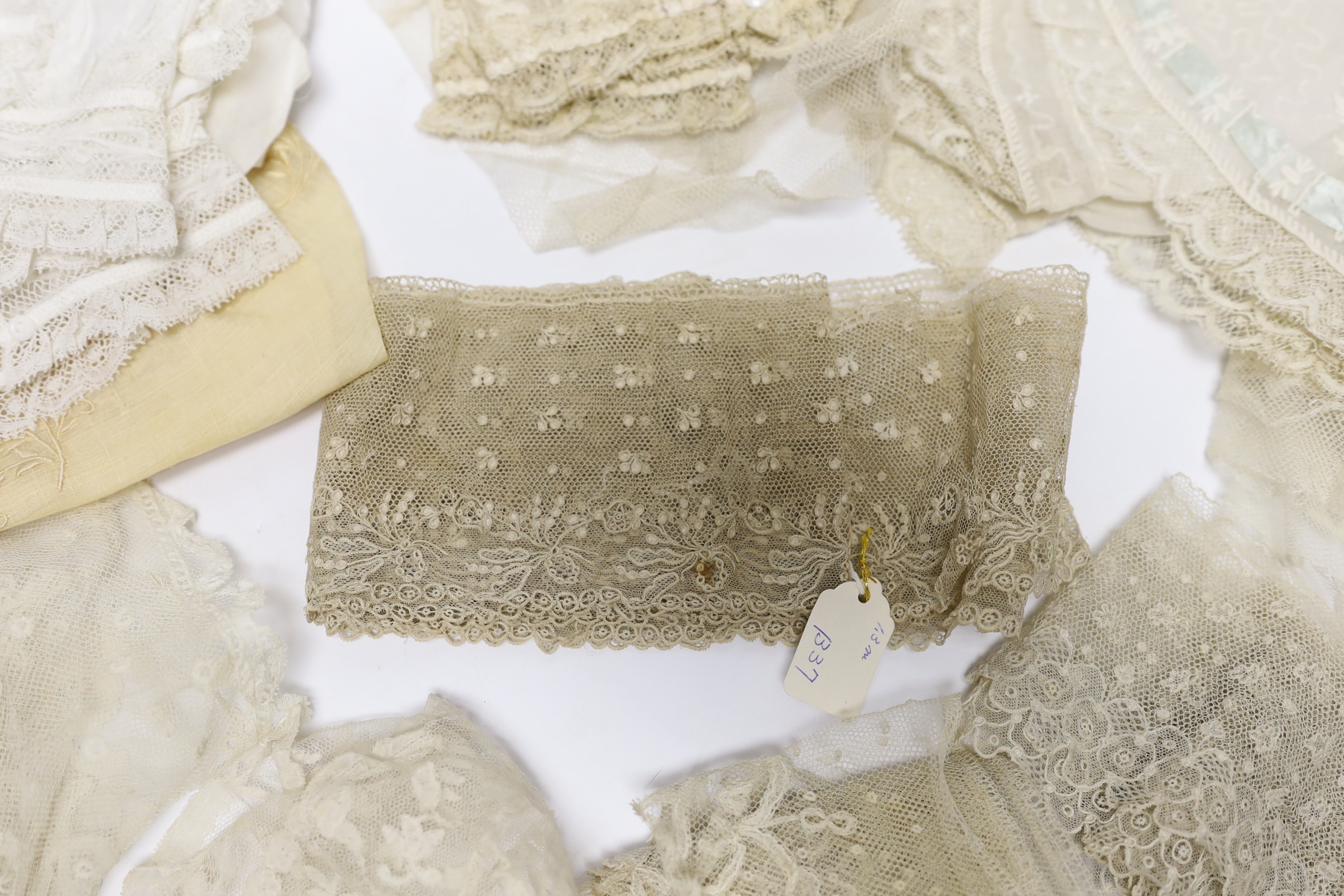 A collection of mostly 19th century French and English needle and bobbin lace trimmings, white worked sleeves, a black silk stole and black lace trimmings etc